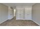 Neutral bedroom featuring carpet floors, two double-door closets, and ample natural light at 4397 Windsor Oaks Cir, Marietta, GA 30066