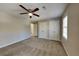 Bedroom featuring carpet floors, a ceiling fan and double door closet space at 4397 Windsor Oaks Cir, Marietta, GA 30066