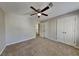 Spacious bedroom with carpet floors, ceiling fan, and double door closet space at 4397 Windsor Oaks Cir, Marietta, GA 30066