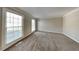 Well-lit bedroom with neutral paint, plush carpet, and bright windows at 4397 Windsor Oaks Cir, Marietta, GA 30066