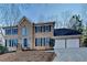 Charming two-story brick home featuring dark blue shutters and a two-car garage at 4397 Windsor Oaks Cir, Marietta, GA 30066