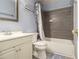 A clean bathroom featuring a shower-tub combo with a modern tile backsplash and a coordinating vanity at 4865 Fenbrook Dr, Stone Mountain, GA 30088