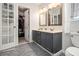Well-designed bathroom with double sink vanity, tiled floor, and adjacent closet at 4865 Fenbrook Dr, Stone Mountain, GA 30088