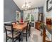 Formal dining room with vaulted ceiling, stylish chandelier, and large window with elegant drapery at 4865 Fenbrook Dr, Stone Mountain, GA 30088