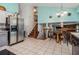 Open-concept kitchen and dining area with tile floors, stainless steel refrigerator and staircase access at 4865 Fenbrook Dr, Stone Mountain, GA 30088