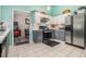 Well-equipped kitchen featuring gray and white cabinets, stainless steel appliances, and tile flooring for a modern touch at 4865 Fenbrook Dr, Stone Mountain, GA 30088