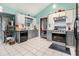 Modern kitchen boasts stainless steel appliances, gray lower cabinets, white upper cabinets, and tile flooring for easy maintenance at 4865 Fenbrook Dr, Stone Mountain, GA 30088