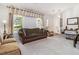 Inviting living room featuring a comfortable sofa, neutral carpet, and bright natural light, creating a welcoming atmosphere at 4865 Fenbrook Dr, Stone Mountain, GA 30088