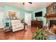Cozy living room with a stone fireplace, a TV, a comfortable recliner, bright paint, and tile flooring at 4865 Fenbrook Dr, Stone Mountain, GA 30088