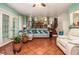 Comfortable living room featuring a sectional sofa, tile flooring, a view into the kitchen, and a door leading to the backyard at 4865 Fenbrook Dr, Stone Mountain, GA 30088