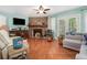 Spacious living room boasting a cozy fireplace, a TV, access to the backyard, and a comfortable seating area at 4865 Fenbrook Dr, Stone Mountain, GA 30088