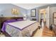 Bright main bedroom with wood floors, a cozy bed, and plenty of natural light at 4865 Fenbrook Dr, Stone Mountain, GA 30088