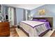 Main bedroom features a large bed, wood floors, soft lighting and ample space at 4865 Fenbrook Dr, Stone Mountain, GA 30088