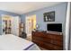 This main bedroom offers wood floors, a TV, a dresser, and comfortable decor at 4865 Fenbrook Dr, Stone Mountain, GA 30088