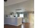 Open kitchen featuring white cabinets, ample counter space, and wood flooring, perfect for cooking at 783 Fox Valley Dr, Stone Mountain, GA 30088