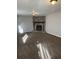 Cozy living room featuring a stone fireplace, neutral walls, and plush carpeting at 783 Fox Valley Dr, Stone Mountain, GA 30088