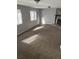 Bright living room featuring neutral walls, plush carpeting, and a stone fireplace at 783 Fox Valley Dr, Stone Mountain, GA 30088
