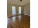 Spacious living area with hardwood floors and two windows offering bright, natural light at 783 Fox Valley Dr, Stone Mountain, GA 30088