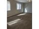 Bright living room featuring neutral walls, plush carpeting, and natural light at 783 Fox Valley Dr, Stone Mountain, GA 30088