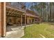 Spacious backyard featuring a covered patio, deck, and ample green space at 100 Hall Pl, Fayetteville, GA 30215