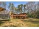 Lush backyard view showcasing a deck, two-story home, and green lawn at 100 Hall Pl, Fayetteville, GA 30215