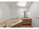 Bright bathroom with a soaking tub, granite counters, stylish mirrors and a skylight at 100 Hall Pl, Fayetteville, GA 30215