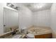 Bright bathroom featuring a corner soaking tub, granite vanity, and modern fixtures at 100 Hall Pl, Fayetteville, GA 30215