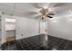 Bedroom featuring black tile floor, neutral walls, ceiling fan, and closet for ample storage at 100 Hall Pl, Fayetteville, GA 30215