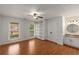 Bright bedroom with wood floors, built-in shelving, and an ensuite bathroom at 100 Hall Pl, Fayetteville, GA 30215