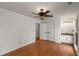 Bright bedroom with wood floors, a ceiling fan, and access to an ensuite bathroom at 100 Hall Pl, Fayetteville, GA 30215