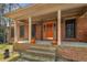 Inviting front porch with brick steps, columns, and a brightly colored front door at 100 Hall Pl, Fayetteville, GA 30215