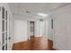 Hallway view with wood floor, white walls, and doors leading to other rooms and storage at 100 Hall Pl, Fayetteville, GA 30215