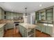 Charming kitchen with custom cabinetry, granite countertops, stainless steel appliances, and stylish pendant lighting at 100 Hall Pl, Fayetteville, GA 30215