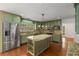 Well-equipped kitchen with custom cabinetry, stainless steel appliances, and a granite-topped central island at 100 Hall Pl, Fayetteville, GA 30215
