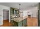 Open concept kitchen with custom cabinetry, granite counters, island, and view to the living room at 100 Hall Pl, Fayetteville, GA 30215