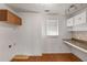 Bright laundry room with hardwood floors and built-in cabinets at 100 Hall Pl, Fayetteville, GA 30215