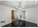 Room featuring black tile floor, chandelier lighting, and white colored walls throughout at 100 Hall Pl, Fayetteville, GA 30215