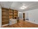 Room with wood flooring, built-in bookcase, and french doors that lead into the next room at 100 Hall Pl, Fayetteville, GA 30215