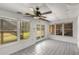 Bright sunroom with tile floor and large windows offering views of the outdoor greenery at 100 Hall Pl, Fayetteville, GA 30215