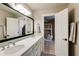Bathroom featuring dual sinks, white cabinets, and modern fixtures next to a bedroom at 285 Lackland Court, Sandy Springs, GA 30350
