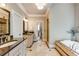 Bright bathroom featuring double vanities, granite countertops, a soaking tub, and walk-in shower at 285 Lackland Court, Sandy Springs, GA 30350