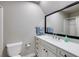 Clean bathroom featuring a vanity with white cabinetry, quartz countertop, modern sink, and a large framed mirror at 285 Lackland Court, Sandy Springs, GA 30350