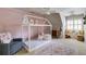 Charming bedroom with a house frame bed, pink accent wall, decorative rug, and reading nook at 285 Lackland Court, Sandy Springs, GA 30350