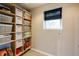Organized closet with built-in shelving, storage baskets, and a small window with a woven shade at 285 Lackland Court, Sandy Springs, GA 30350
