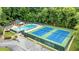 Aerial view of a community pool and tennis courts surrounded by lush greenery at 285 Lackland Court, Sandy Springs, GA 30350
