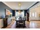 Stylish dining room with navy blue walls, modern chandelier, and elegant furnishings at 285 Lackland Court, Sandy Springs, GA 30350