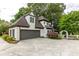 Stately two-story home with a Tudor-style design, attached garage, and charming landscaping at 285 Lackland Court, Sandy Springs, GA 30350