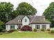 Charming two-story home with a manicured lawn, lush landscaping, and inviting entrance at 285 Lackland Court, Sandy Springs, GA 30350