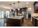 Gourmet kitchen featuring granite countertops, dark wood cabinets, stainless steel appliances, and breakfast nook at 285 Lackland Court, Sandy Springs, GA 30350