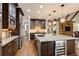 Gourmet kitchen with granite countertops, dark wood cabinets, stainless steel appliances, and wine fridge at 285 Lackland Court, Sandy Springs, GA 30350